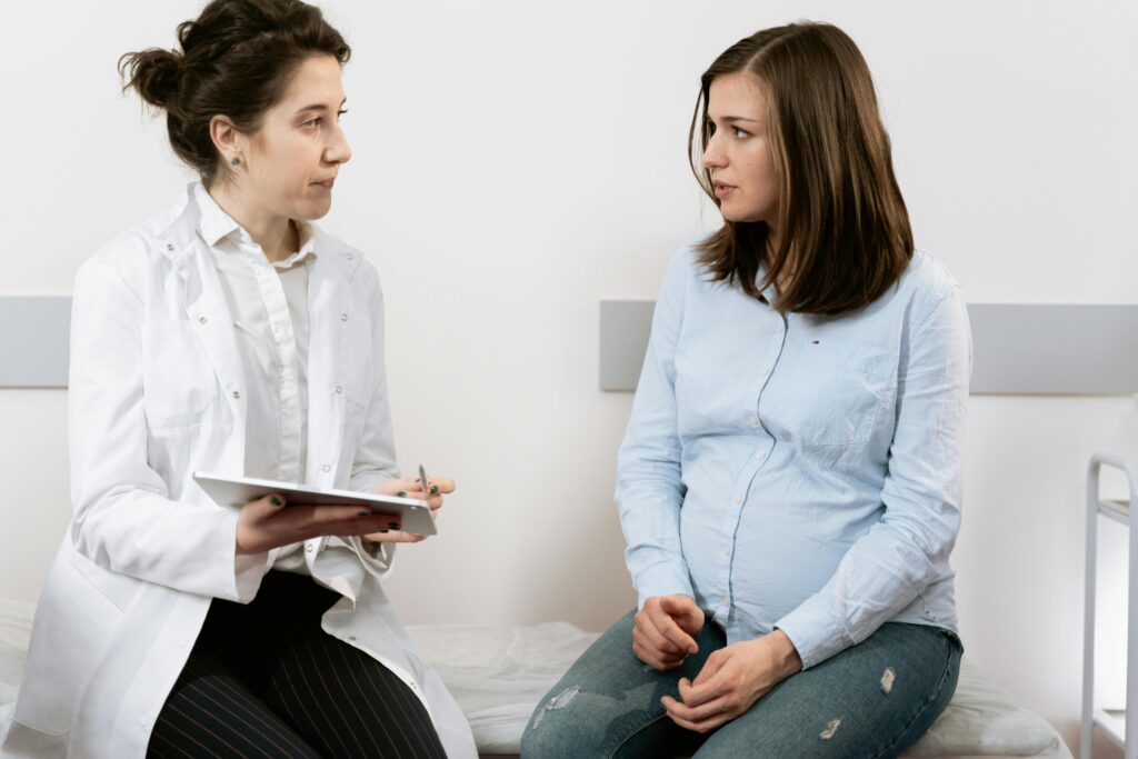Doctor explaining to pregnant woman the health risk of testing positive for Group B Strep